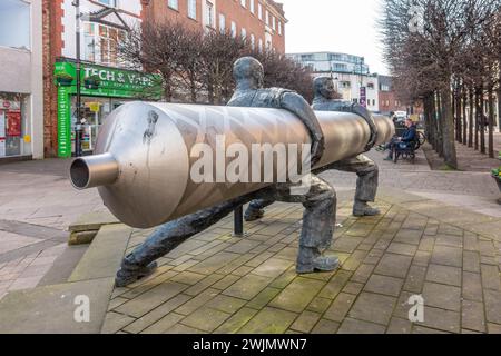 'Roll out the Lino' is a sculpture by David Annand and stand in The High Street in Staines-upon-Thames in Surrey, UK Stock Photo