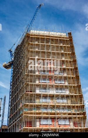 A new tower block under construction, surrounding by scaffolding in Staines-upon-Thames in Surrey, UK Stock Photo