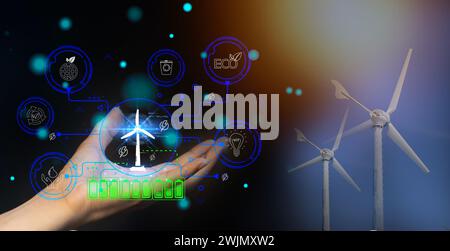 Technology for the environment Using environmentally friendly technology Engineer designs wind turbine models clean energy network Stock Photo