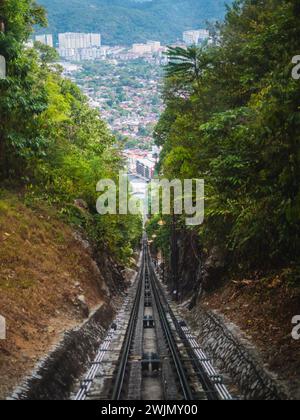 Cable car or tram uphill in Penang Malaysia. The Penang Hill Railroad track. View of the funicular railway going up Penang Hill. Stock Photo