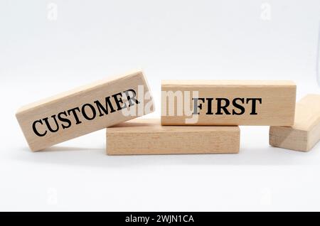 Customer first text on wooden blocks. Customer centric concept. Stock Photo