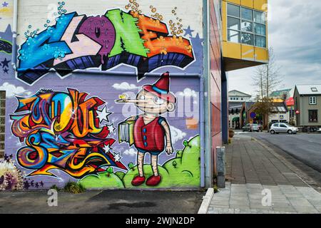 Colourful street art mural with cartoon characters and graffiti on a building wall in Reykjavik, Iceland, Stock Photo