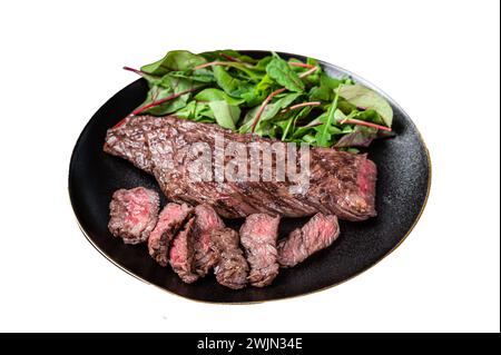 Juicy Grilled Machete skirt beef meat steak on plate with salad Isolated on white background. Top view Stock Photo