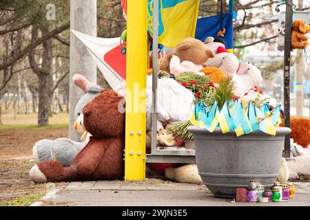 Dnipro, Ukraine, flowers, children's toys, candles, a place of memory near a residential building at a bus stop, destroyed by a Russian missile, the f Stock Photo