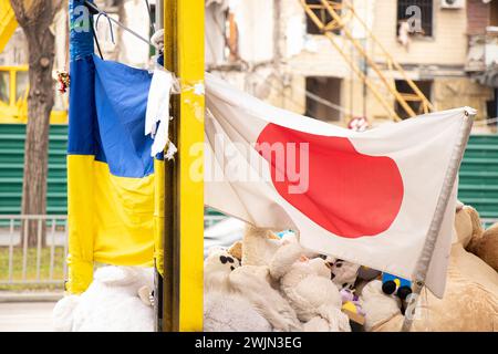 Dnipro, Ukraine, flowers, children's toys, candles, a place of memory near a residential building at a bus stop, destroyed by a Russian missile, the f Stock Photo