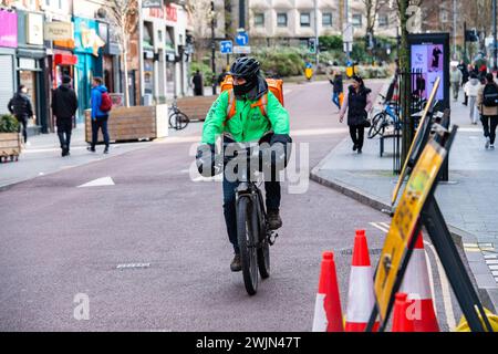 Leicester, Leicestershire, UK. 16th February 2024. Just Eat, Uber Eats and Deliveroo cyclists working in Leicester City Centre. Credit: Alex Hannam/Alamy Live News Stock Photo