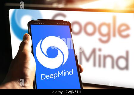human hand holding android phone with artificial intelligence company website Google DeepMind in front of business logo, editorial news Stock Photo
