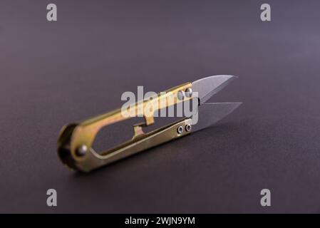 Tailor mini thread cutter on a gray background Stock Photo - Alamy
