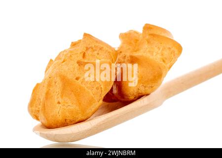 Two delicious eclairs on a wooden spoon, macro, isolated on white background. Stock Photo