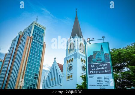 The spire of Catholic St Joseph's Cathedral next to modern high rise office buildings in central Dar es Salaam in Tanzania. Stock Photo