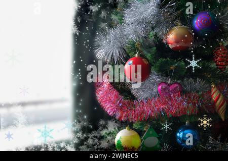 Fragment of beautiful christmas tree decorated and lighted with gifts and ornaments for Christmas and for New Year Eve. Stock Photo