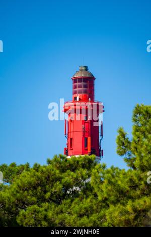 View on red lighthouse Le Phare du Cap Ferret, Arcachon Bay with many fisherman's boats and oysters farms near , Cap Ferret peninsula, France, southwe Stock Photo