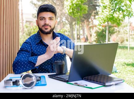 Stylish young businessman working outdoors. Stock Photo