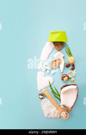 Macadamia nuts, coconut, coconut flour and milk on blue background. Product design. Top view  Stock Photo