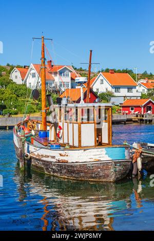 Old fishing boat at a jetty in a fishing village on the Swedish west coast, Hamburgsund, Bohuslaen, Sweden Stock Photo