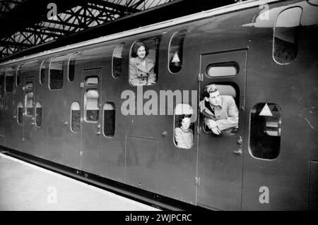 Britain's First 'Double Deck' Train Now In Service -- Passengers in the novel 'double decker' waiting to commence their first trip in the new train. Britain's first 'double deck' electric train is now in service between London and Dartford, Kent. The train - of eight coaches - has seating accommodation for 1,104 passengers against the 772 carried by the older type. The train has been designed in an effort to solve the problem of getting the rush-hour crowds away from the City to their suburban homes in comfort and with speed. November 1, 1949. (Photo by S&G). Stock Photo