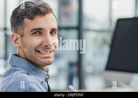 happy freelancer looking at camera during making project for remote job making notes. Stock Photo
