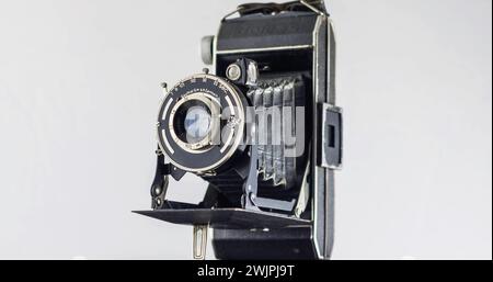 Old Camera black-chrome body, on white background. Old film bellow camera Stock Photo