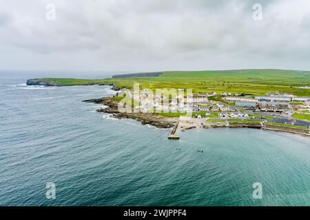 Aerial view of Kilkee, small coastal town, popular as a seaside resort, located in horseshoe bay and protected from the Atlantic Ocean by the Duggerna Stock Photo