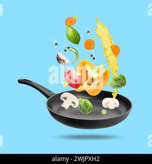 Different vegetables, oil, frying pan in air on light blue background Stock Photo