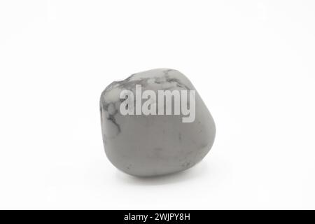 White Howlite is a borate mineral known for its chalky white appearance with dark veins, symbolizing patience and perspective. Stock Photo