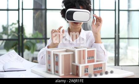 female architect designer examines house layout with 3d glasses Stock Photo