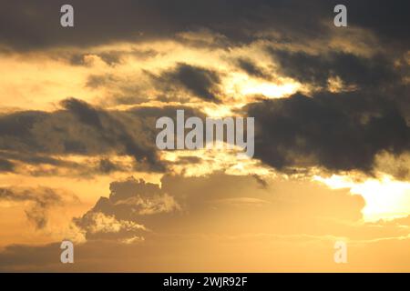 Dramatic sky at sunrise, natural background with cirrus and cumulus clouds Stock Photo