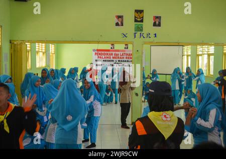 Photo of students joining the Youth Red Cross extracurricular and practicing first aid Stock Photo