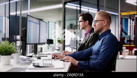 Using Corporate Invoice Spreadsheet On Computer Monitors Stock Photo