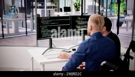Computer Programmer Writing Program Code On Computer In Office Stock Photo