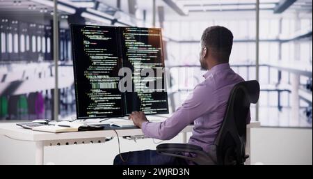 Software Programmer Or Coder Man Using Office Computer Stock Photo