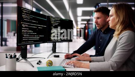 Coder Using Computer At Desk. Web Developer Stock Photo