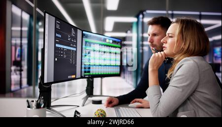 Accountants Looking At Invoice Spreadsheet On Computer Monitor Stock Photo