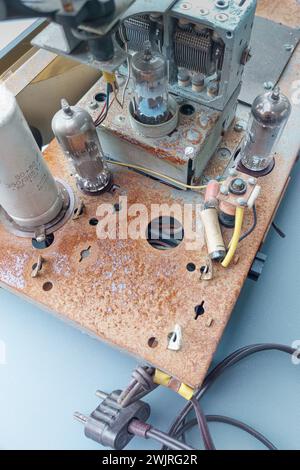 Parts of an antique radio with traces of time. Radio tubes, transistors and so on. Rusty base Stock Photo