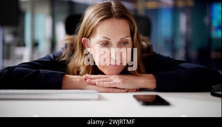 Woman Waiting Phone Call At Office Desk Stock Photo