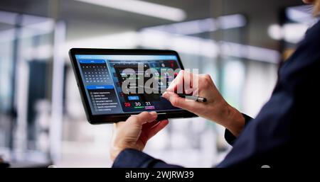 Executive Using Digital Calendar Agenda On Tablet Stock Photo