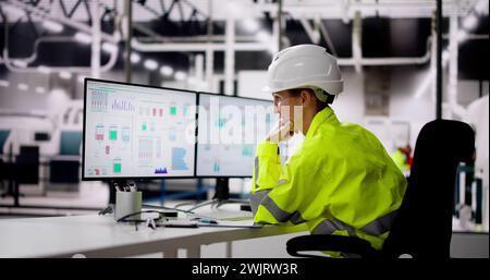 Unhappy Engineer Operator Using SCADA System At Industrial Plant Stock Photo