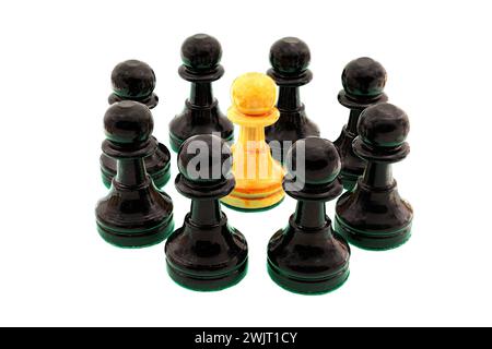Black chess pawns surrounding a single white pawn. Stock Photo