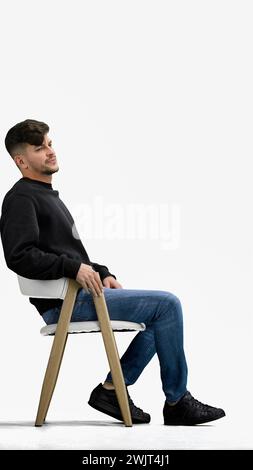 A man, on a white background, sitting on a chair Stock Photo