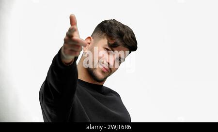 A man, close-up, on a white background, points forward Stock Photo