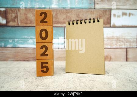 Hand flipping block 2024 to 2025 text on table. Resolution, time, plan, goal, motivation, reboot, countdown and New Year holiday concepts Stock Photo