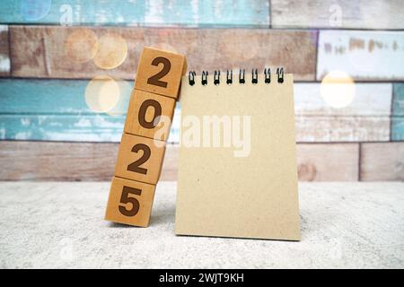 Hand flipping block 2024 to 2025 text on table. Resolution, time, plan, goal, motivation, reboot, countdown and New Year holiday concepts Stock Photo
