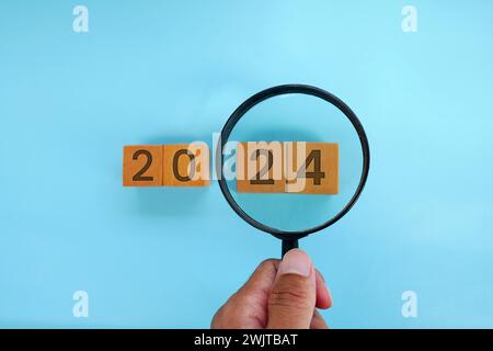 Magnifying glass and targets 2025. Concept of new year 2025, beginning of success, challenge or career path, change, planning, goals, challenges and n Stock Photo