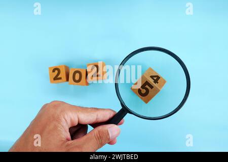 Magnifying glass and targets 2025. Concept of new year 2025, beginning of success, challenge or career path, change, planning, goals, challenges and n Stock Photo