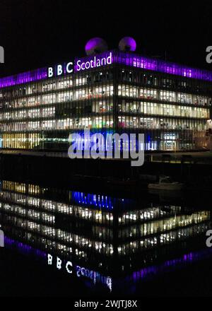 Glasgow Scotland: 11th Feb 2024: River Clyde at night with the BBC Scotland building lit up with water refelction. BBC Pacific Quay Stock Photo