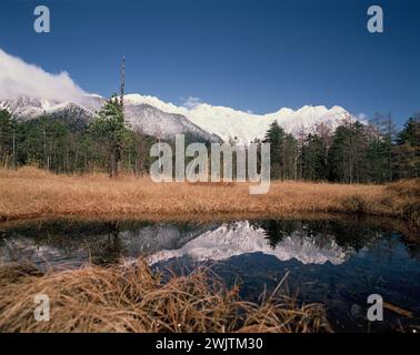 Japan. Nagano. Kamikōchi. Hida Mountains. Mt. Hotaka & Yakedake reflected in Taisho Pond. Stock Photo