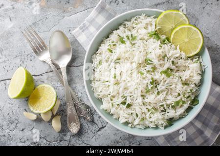 Organic cilantro lime rice with garlic and zest close-up in a bowl on the table. Horizontal top view from above Stock Photo