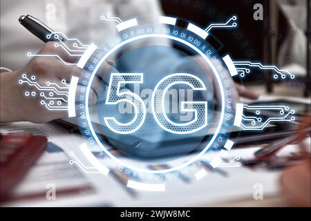 Businesswoman hands using digital tablet and virtual hexagons hologram with digital business icons. Virtual reality and global networking concept. Stock Photo