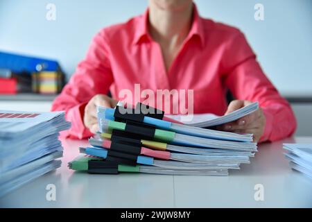 Businesswoman hands holding stacks files, business reports and stock charts. Financial and paperwork concept Stock Photo