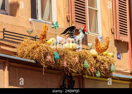 Easter decoration with rooster, hens and chickens in a nest on a house Stock Photo